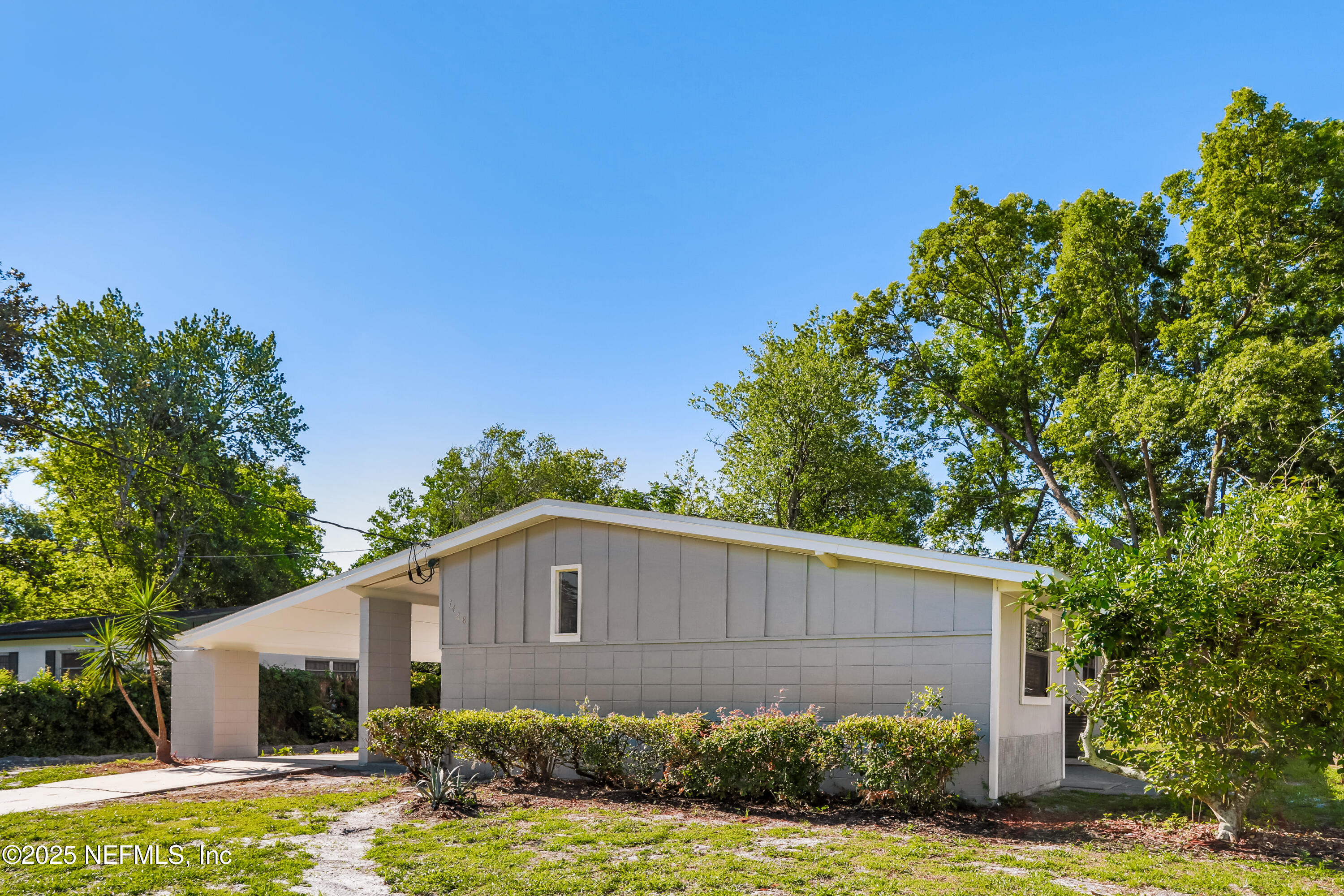 7428 Centauri Road Jacksonville, FL 32210 - Photo 2 of 15 a brick house with a big yard plants and large trees