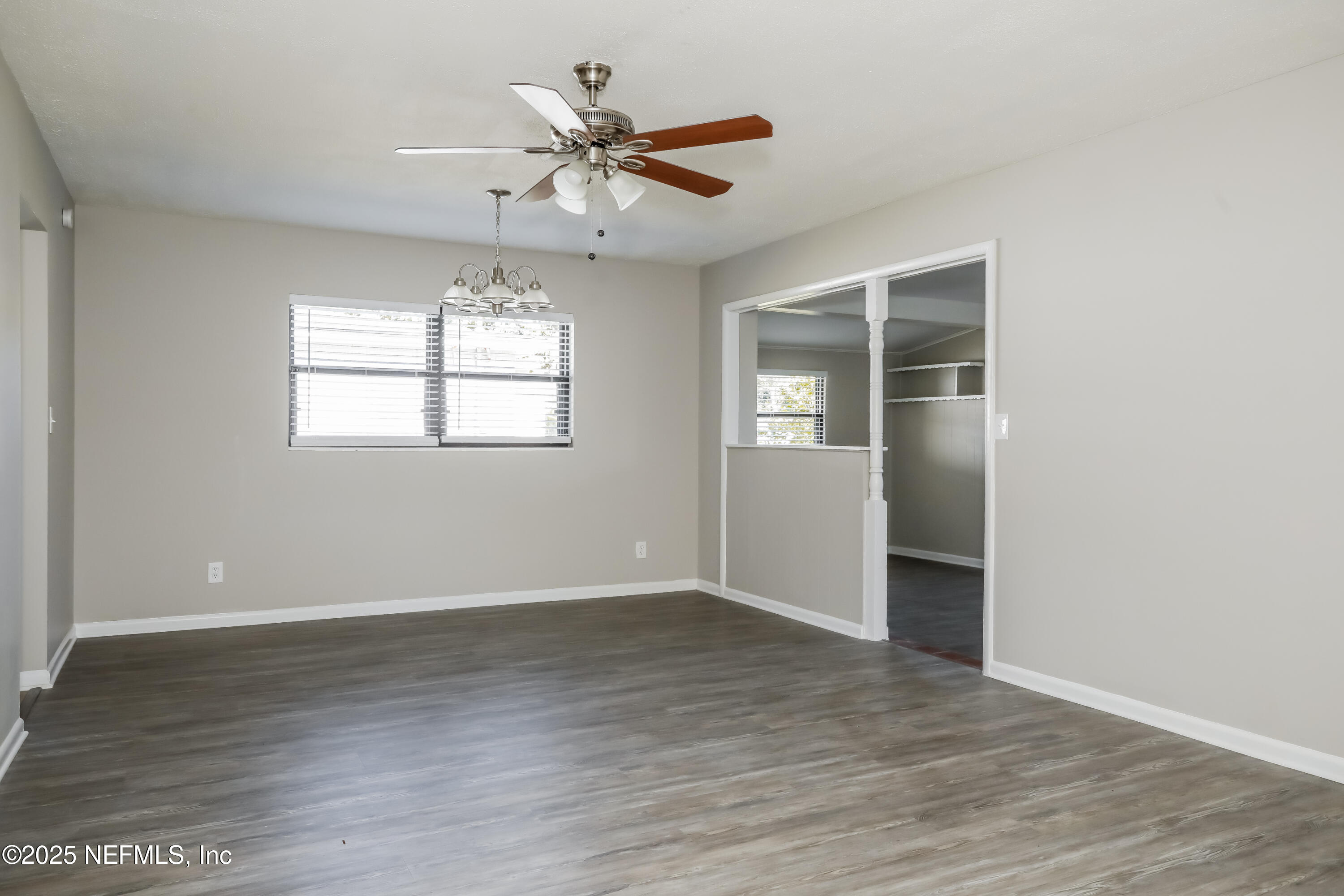 7428 Centauri Road Jacksonville, FL 32210 - Photo 6 of 15 a view of an empty room with wooden floor and a window