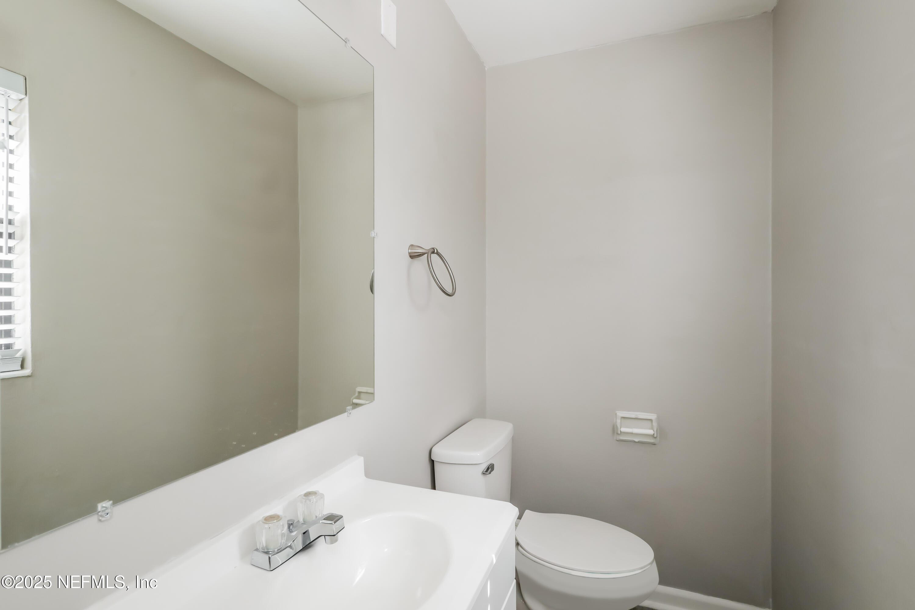 7428 Centauri Road Jacksonville, FL 32210 - Photo 10 of 15 a white toilet sitting next to a bathroom sink