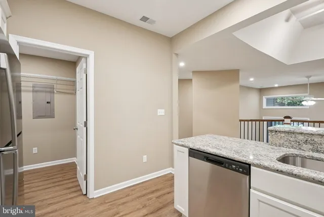 a view of a kitchen with microwave and cabinets