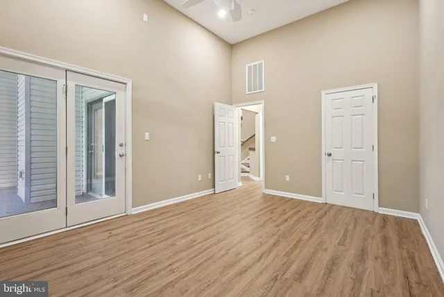 a view of empty room with wooden floor