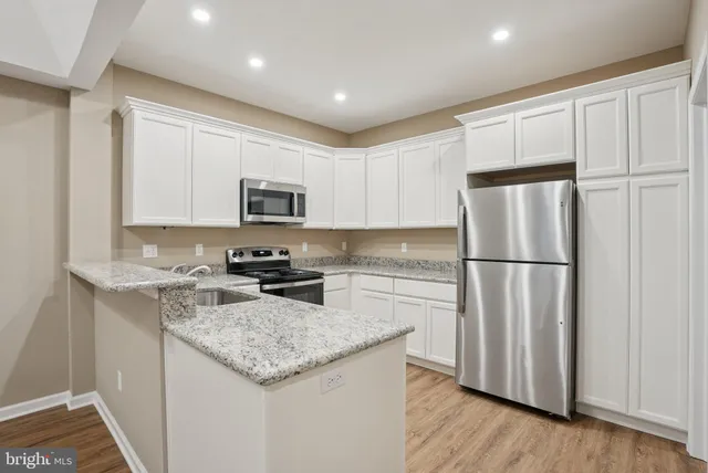 a kitchen with a refrigerator and cabinets
