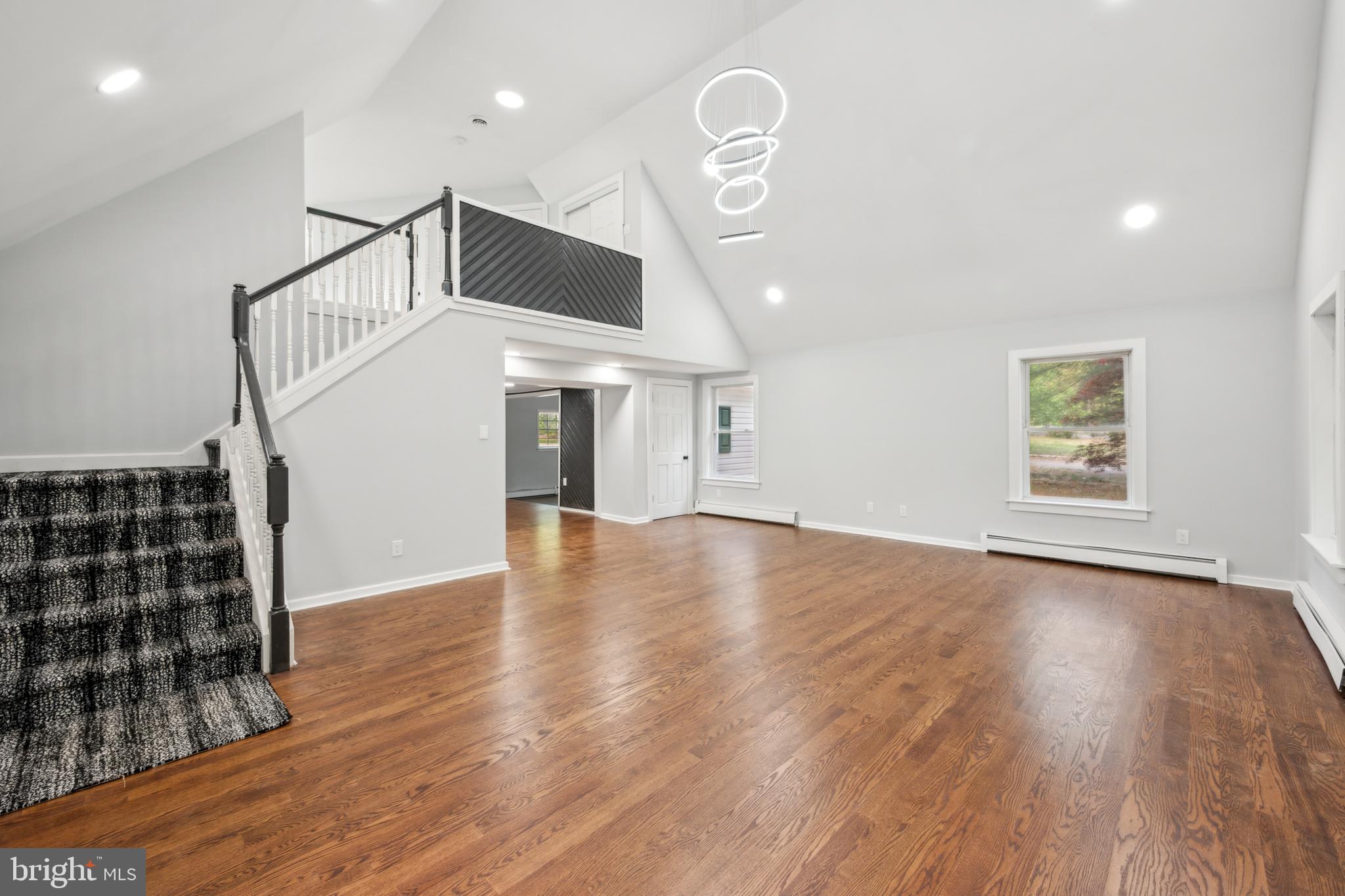 47 Lakeview Drive Tabernacle, NJ 08088 - Photo 11 of 25 an empty room with wooden floor windows and staircase