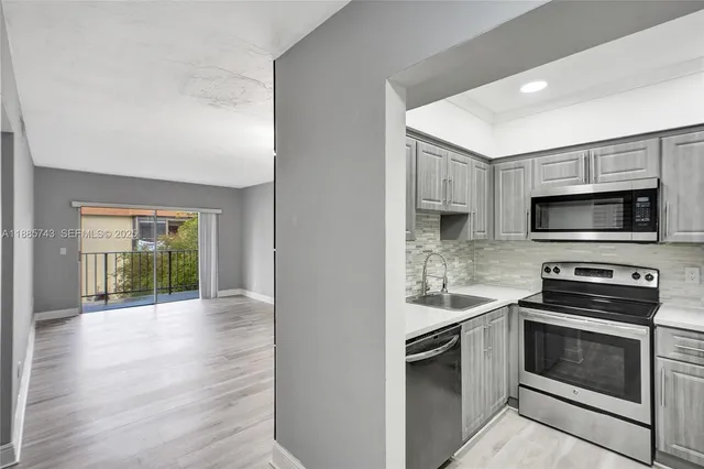 a kitchen with a stove and a microwave