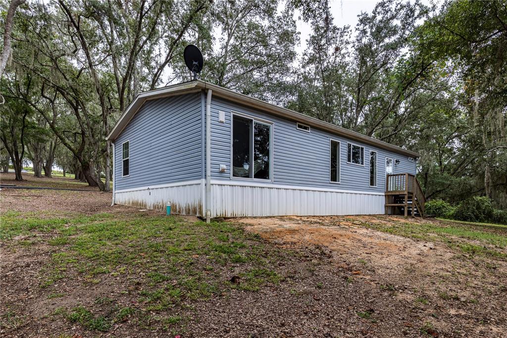 10135 North Em En El Grove Road Leesburg, FL 34788 - Photo 14 of 54 a house with trees in the background