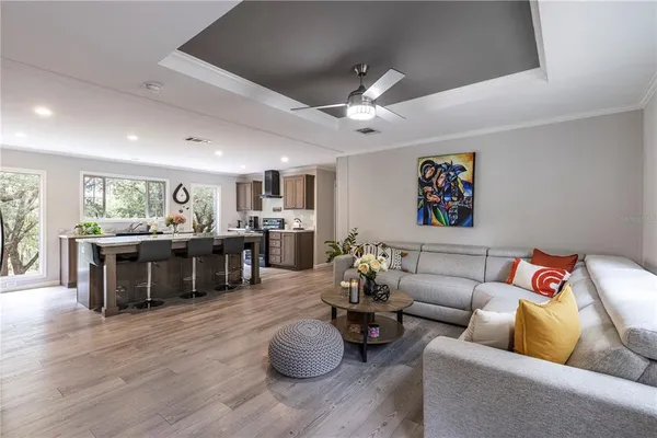 a living room with furniture a mirror and a flat screen tv