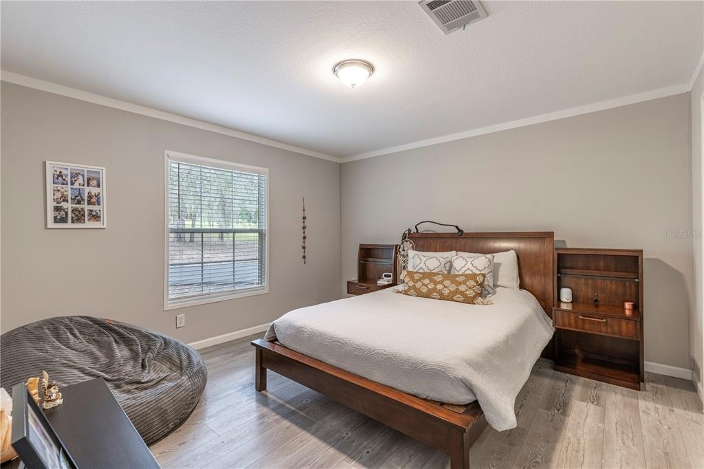 10135 North Em En El Grove Road Leesburg, FL 34788 - Photo 19 of 54 a bedroom with a bed and a window