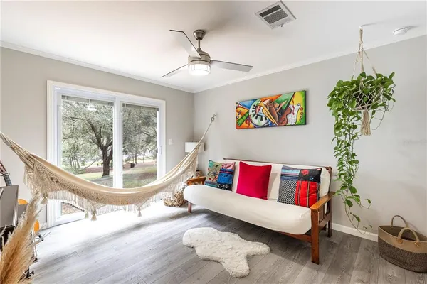 a view of a workspace with furniture and a bookshelf