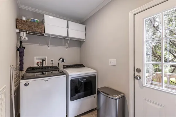 an aerial view of residential house with outdoor space and trees all around