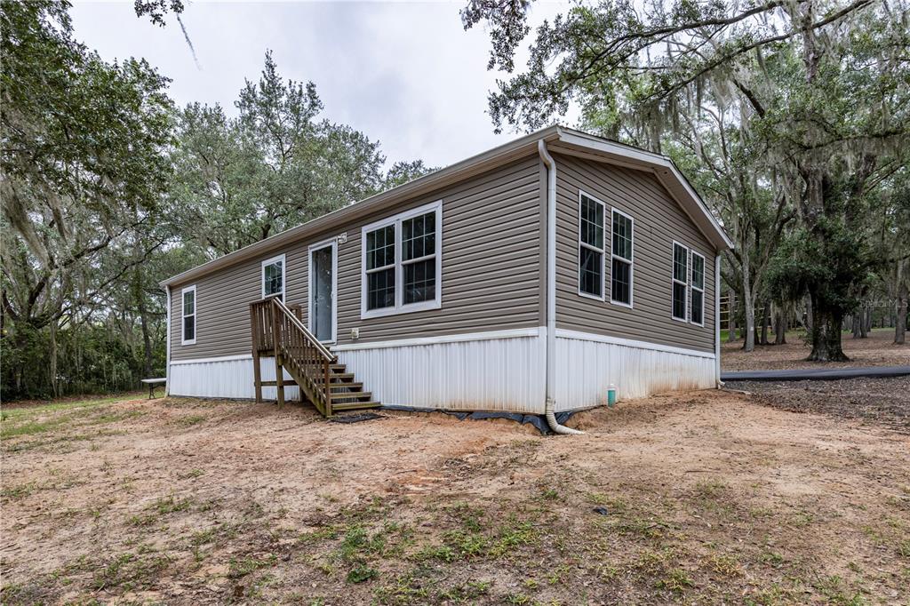 10135 North Em En El Grove Road Leesburg, FL 34788 - Photo 3 of 54 a view of a house with a yard