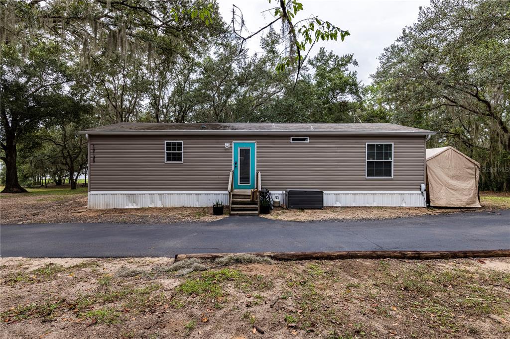 10135 North Em En El Grove Road Leesburg, FL 34788 - Photo 32 of 54 a view of a house with a yard