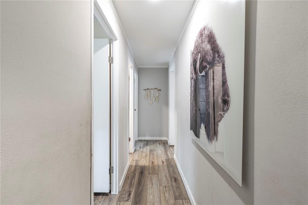 10135 North Em En El Grove Road Leesburg, FL 34788 - Photo 40 of 54 a view of a hallway with wooden floor and staircase