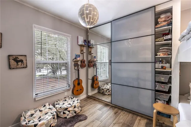 an aerial view of residential house with outdoor space and trees all around