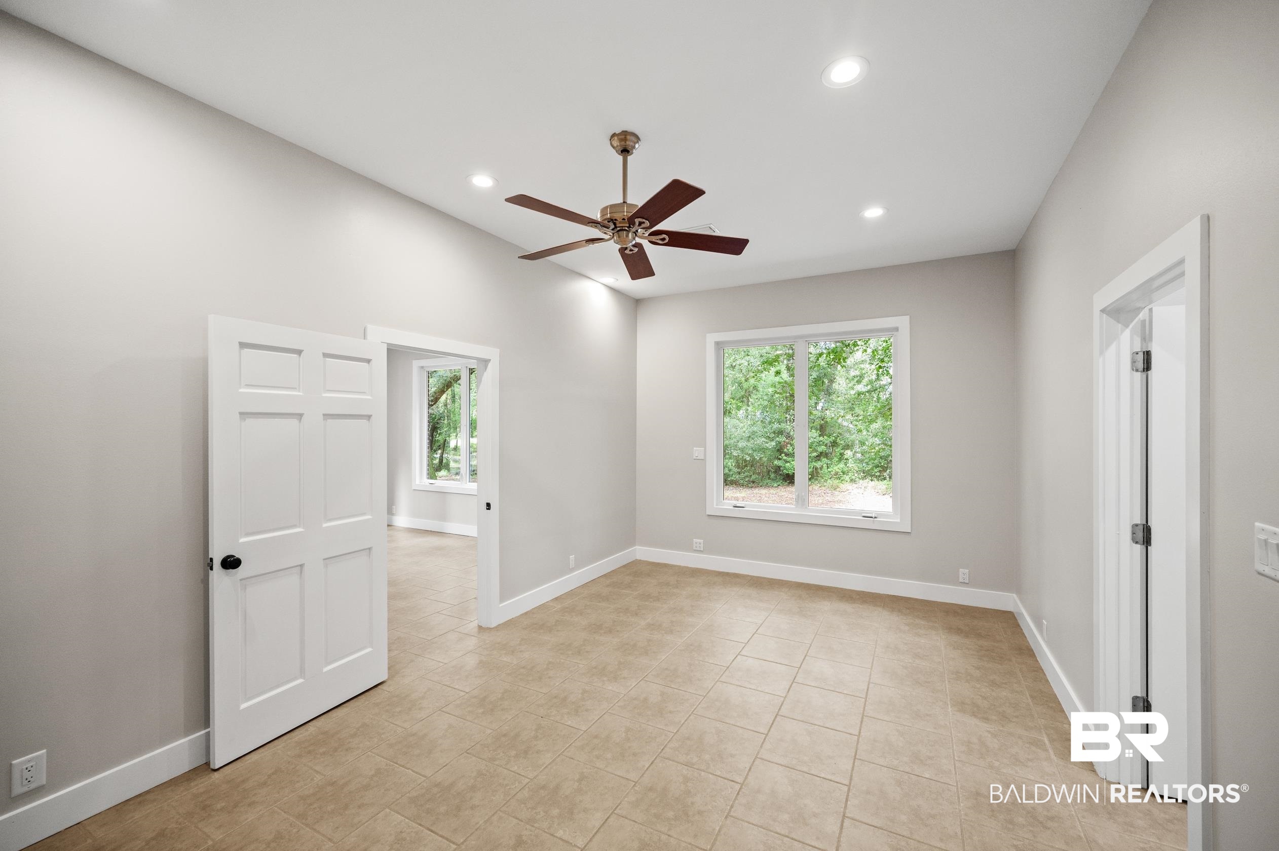 15031 Timber Ridge Drive Loxley, AL 36551 - Photo 20 of 43 Unfurnished room featuring light tile patterned floors, a wealth of natural light, and ceiling fan