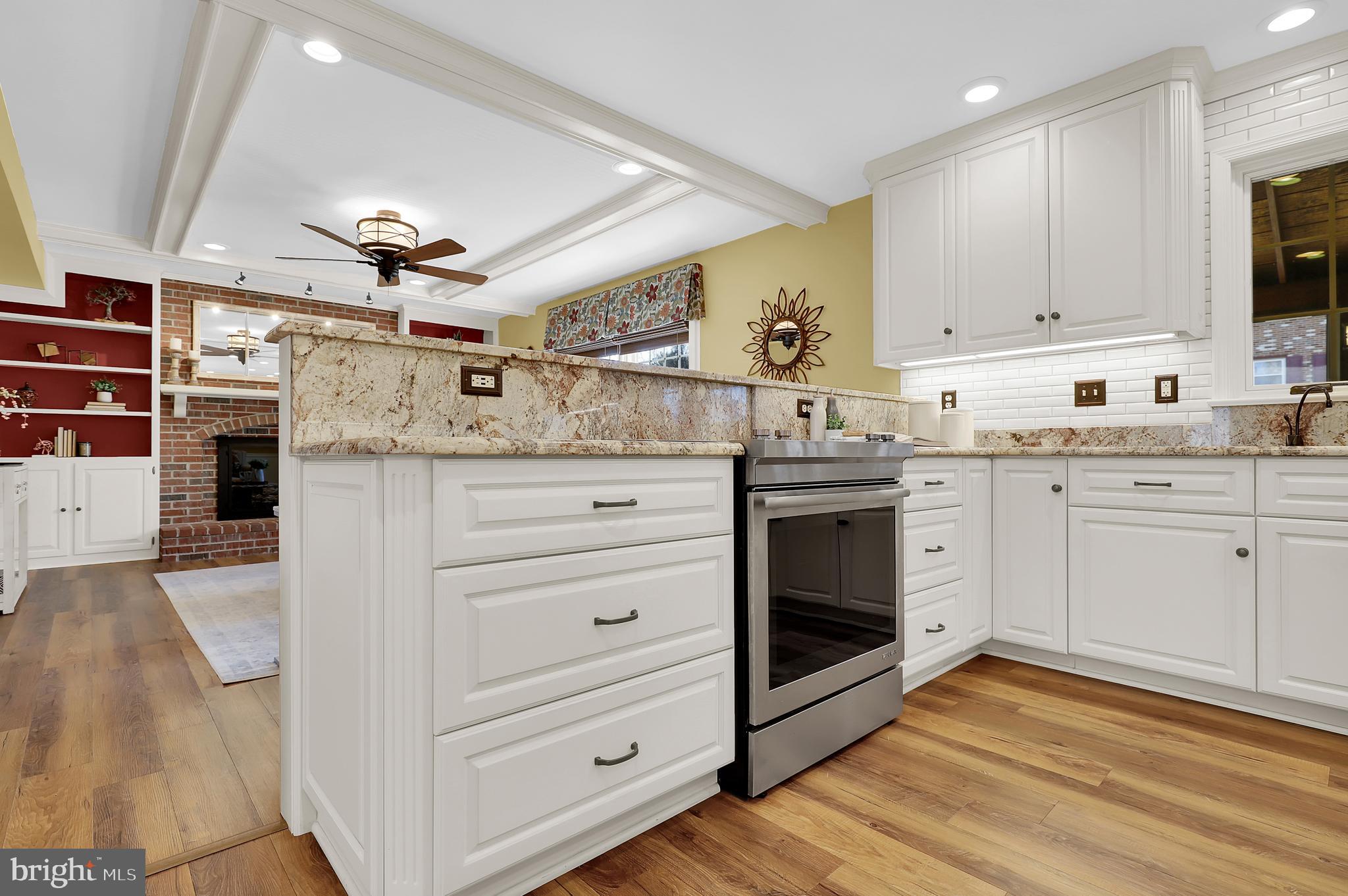 7908 River Run Court Frederick, MD 21701 - Photo 15 of 59 a kitchen with stainless steel appliances granite countertop a stove cabinets and wooden floor