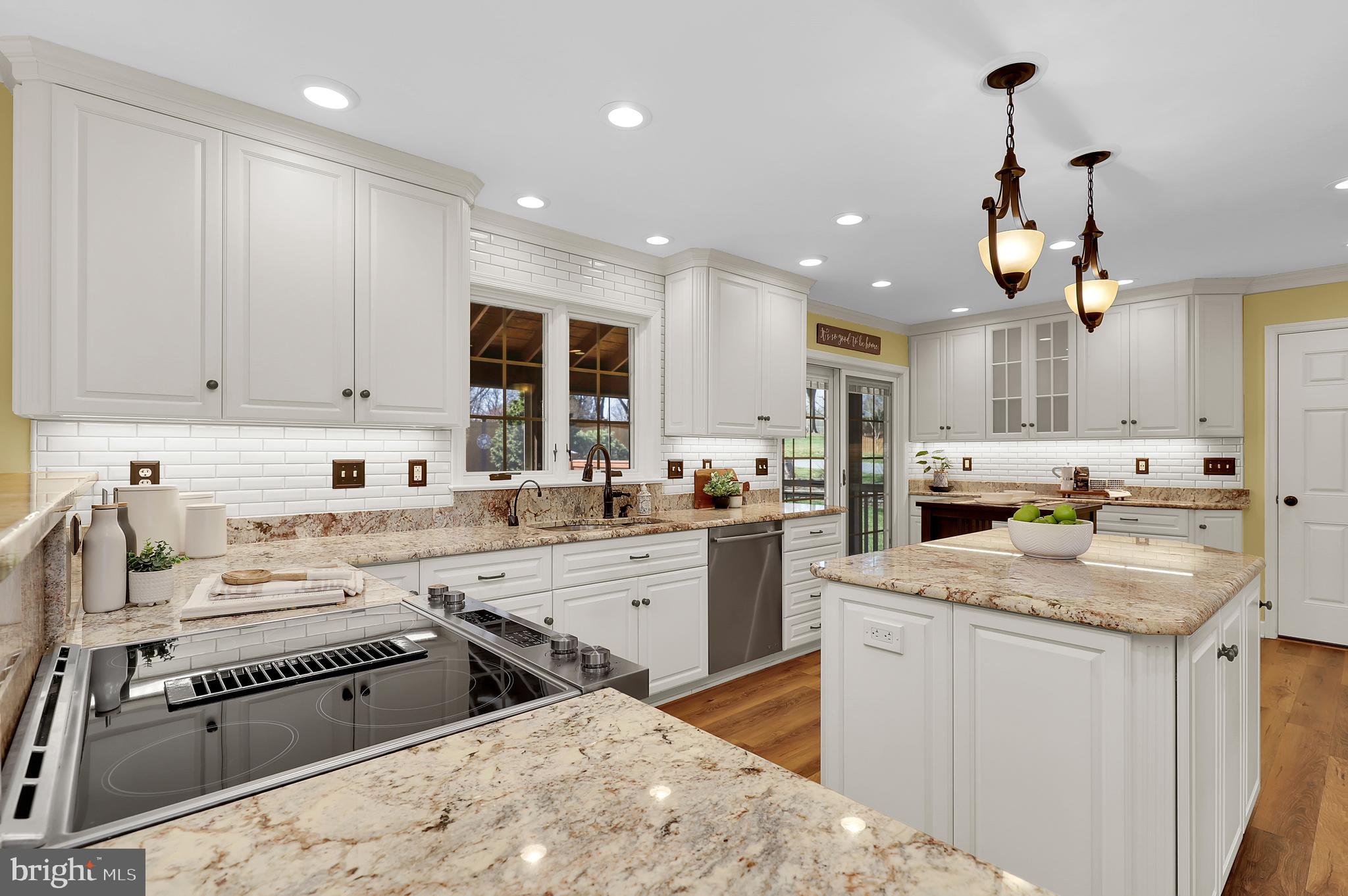 7908 River Run Court Frederick, MD 21701 - Photo 16 of 59 a kitchen that has a lot of cabinets in it with granite countertop stainless steel appliances