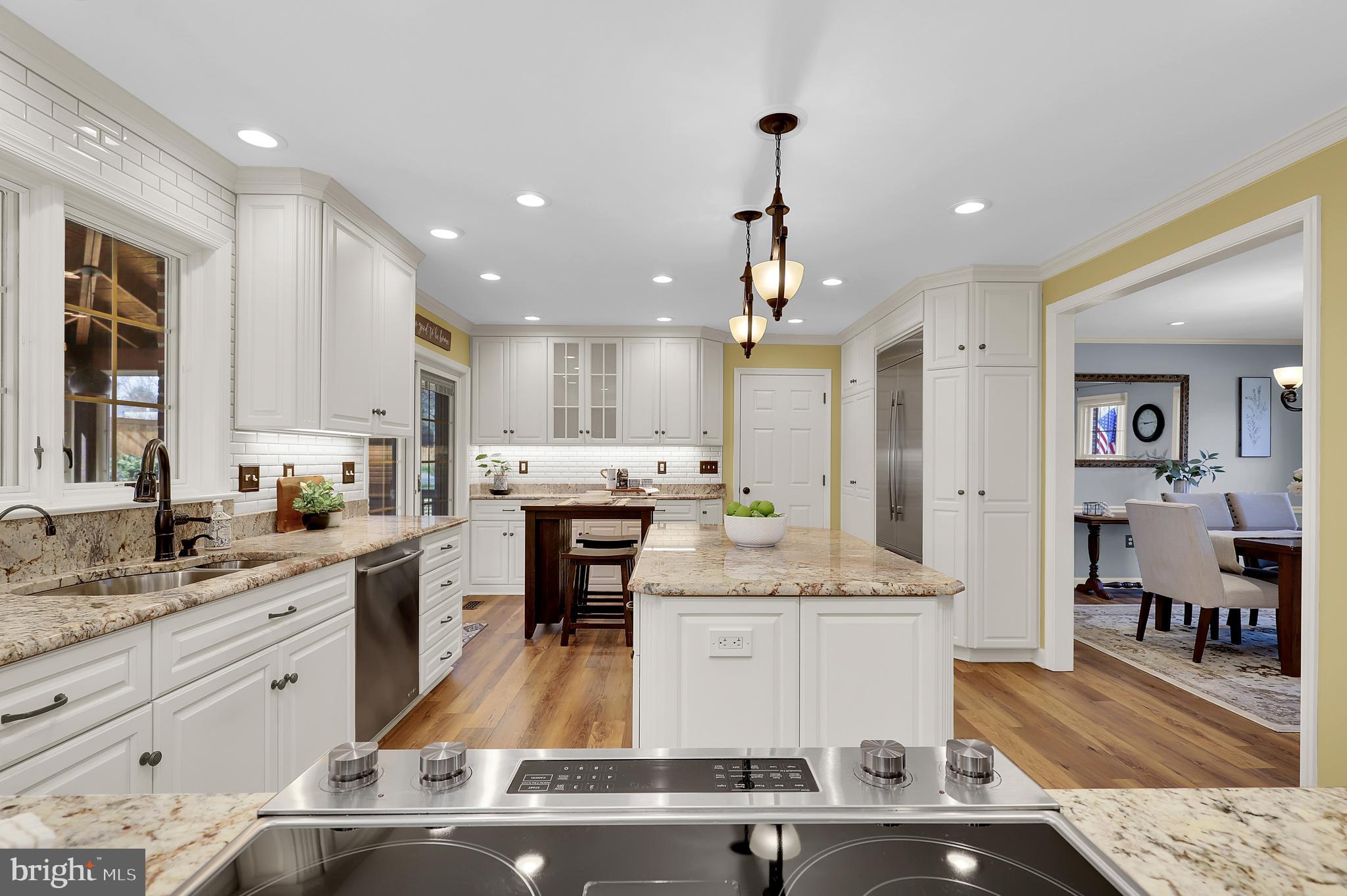7908 River Run Court Frederick, MD 21701 - Photo 17 of 59 a large kitchen with stainless steel appliances kitchen island granite countertop a sink and cabinets