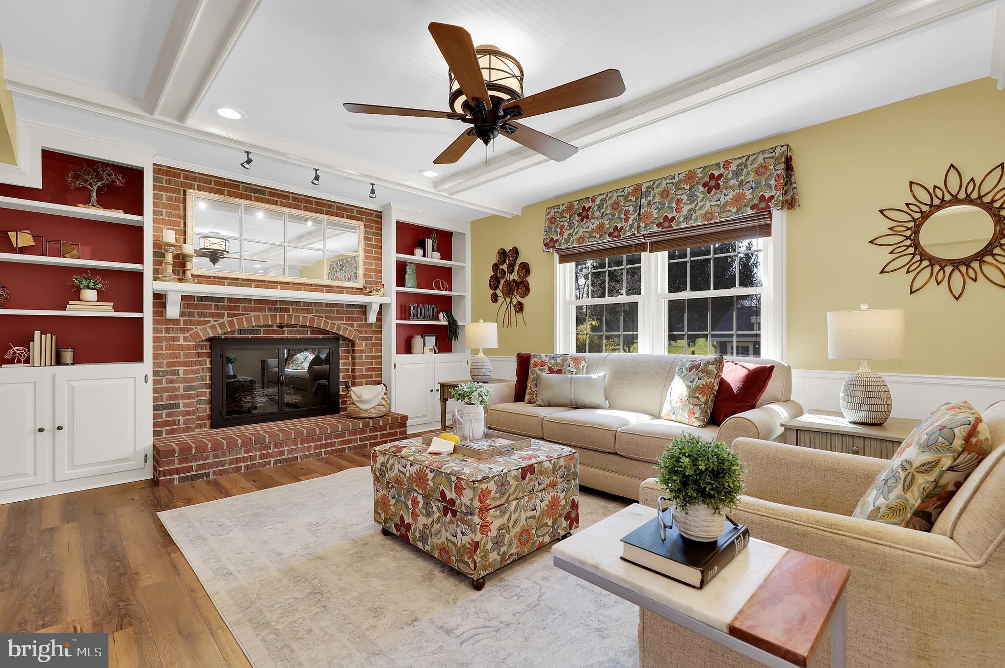 7908 River Run Court Frederick, MD 21701 - Photo 18 of 59 a living room with furniture kitchen view and a fireplace