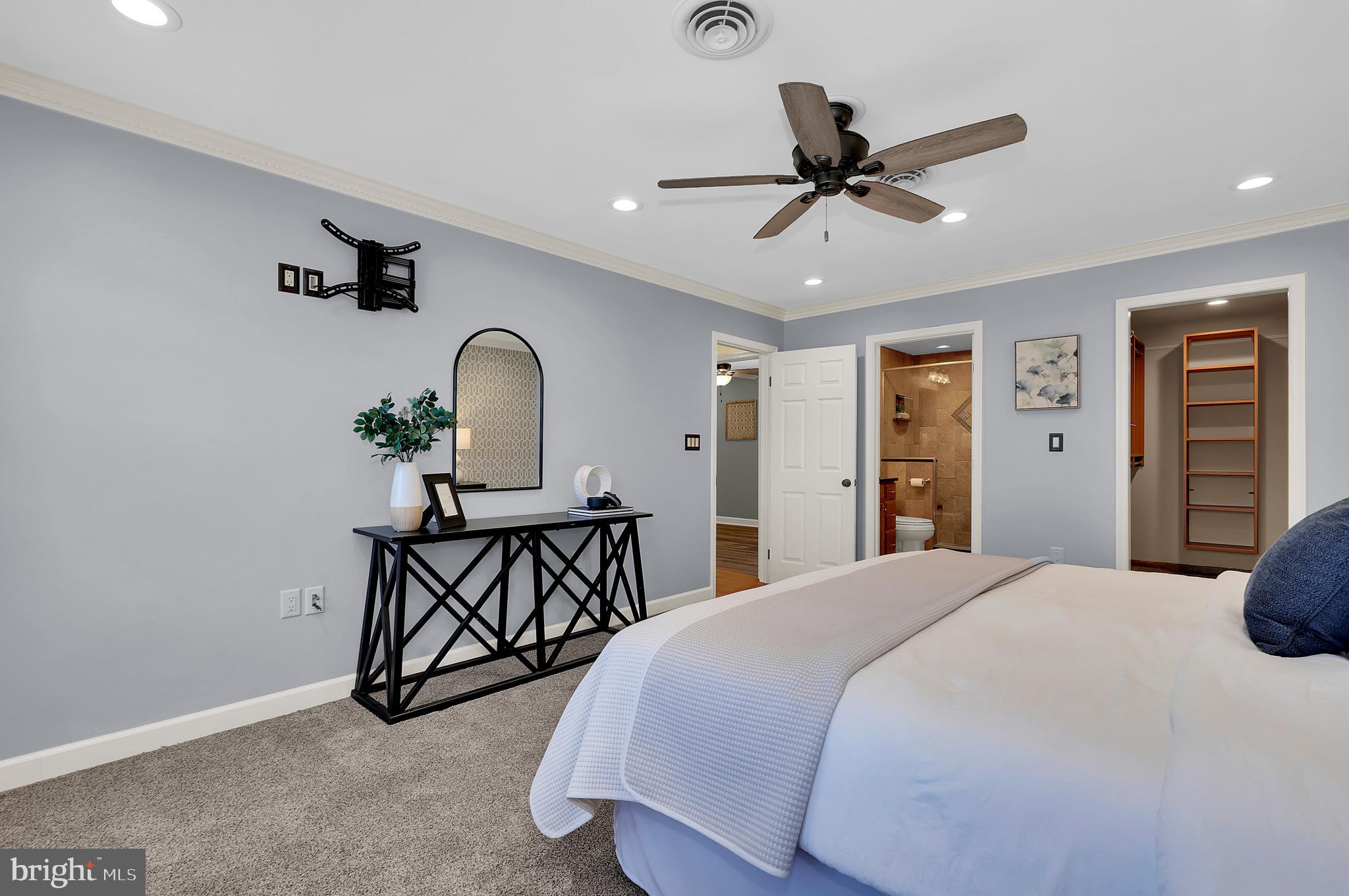 7908 River Run Court Frederick, MD 21701 - Photo 21 of 59 a bedroom with a bed and a table