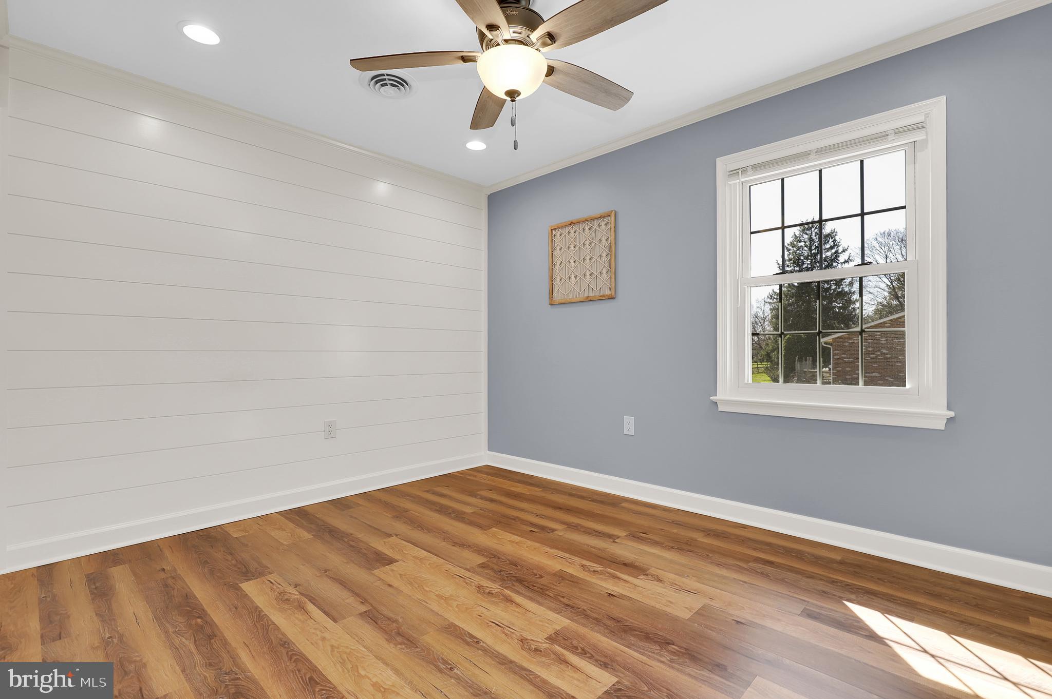 7908 River Run Court Frederick, MD 21701 - Photo 25 of 59 an empty room with a window and a fan