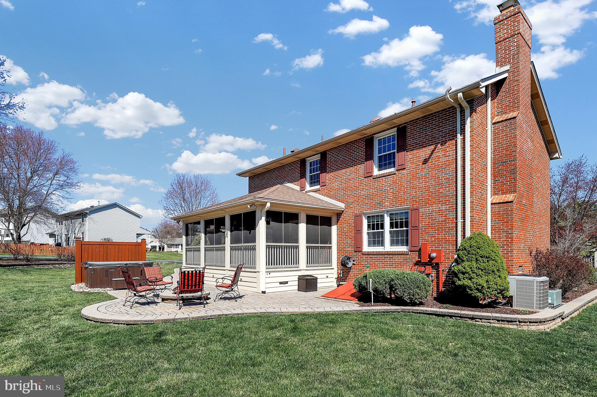 7908 River Run Court Frederick, MD 21701 - Photo 44 of 59 a front view of a house with a yard table and chairs