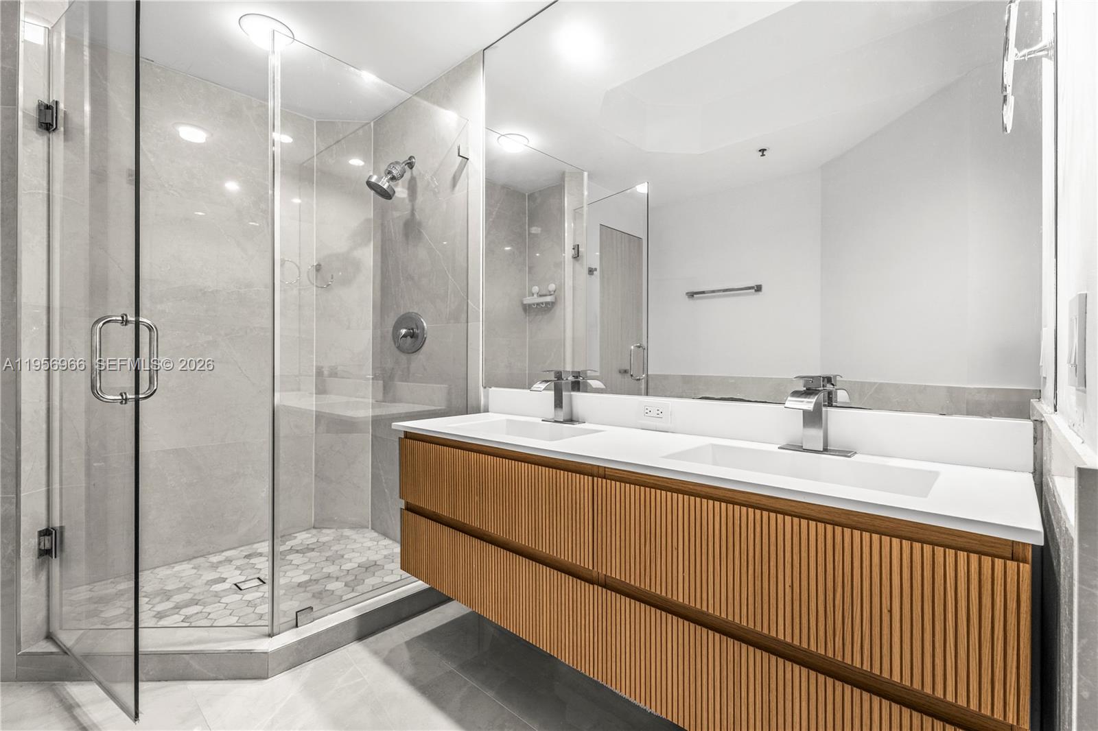 808 Brickell Key Drive, Unit 3007 Miami, FL 33131 - Photo 12 of 16 a spacious bathroom with a shower sink and mirror