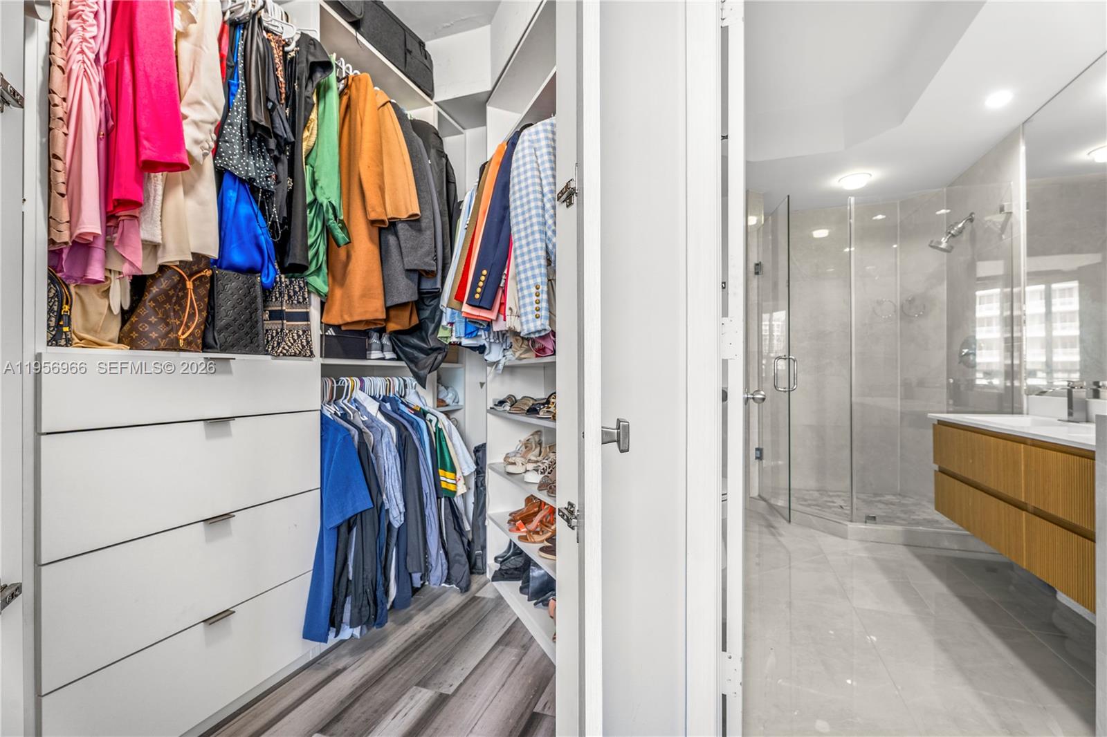 808 Brickell Key Drive, Unit 3007 Miami, FL 33131 - Photo 13 of 16 a view of walk in closet with clothes
