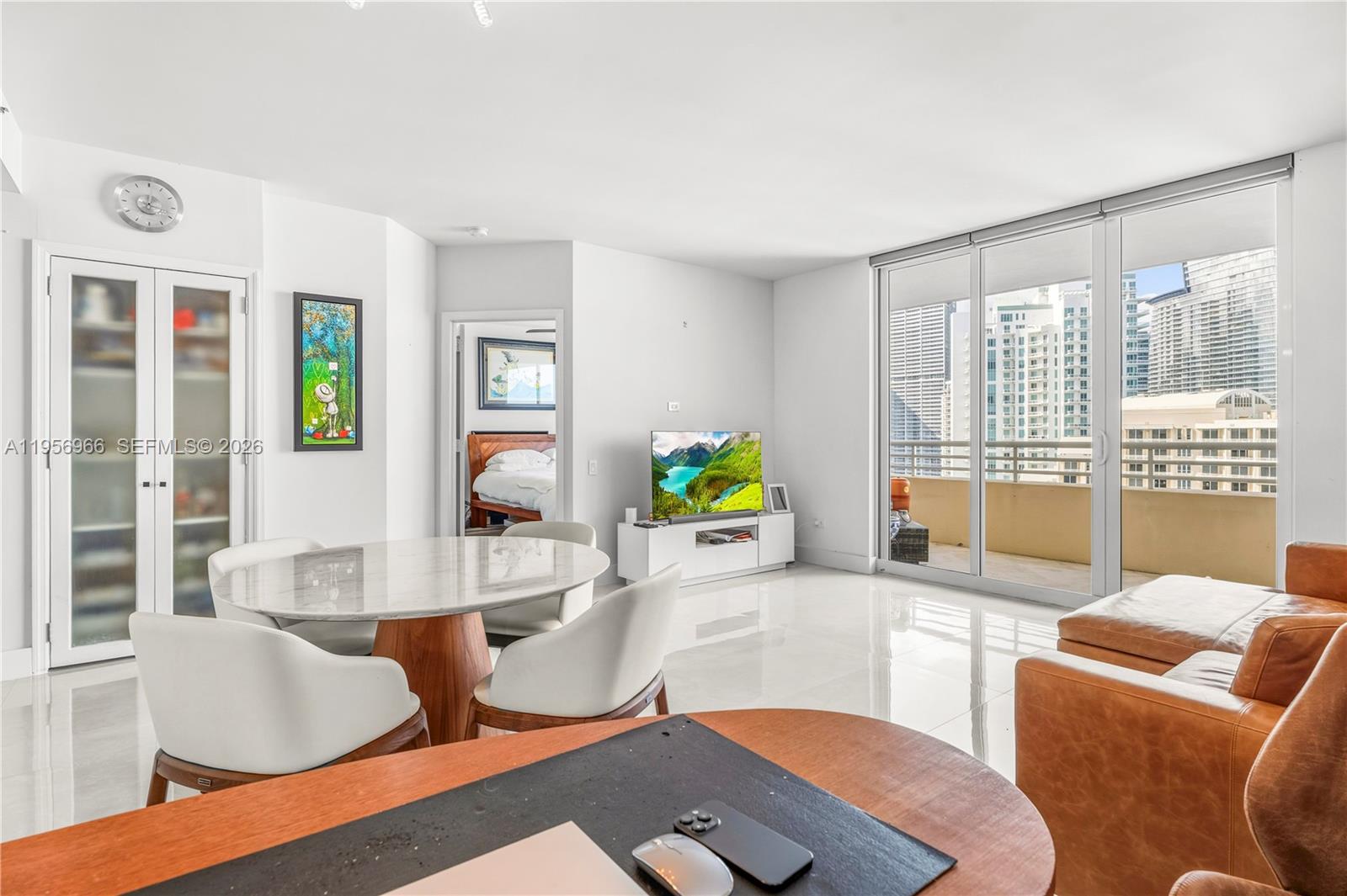 808 Brickell Key Drive, Unit 3007 Miami, FL 33131 - Photo 2 of 16 a living room with furniture and a large window