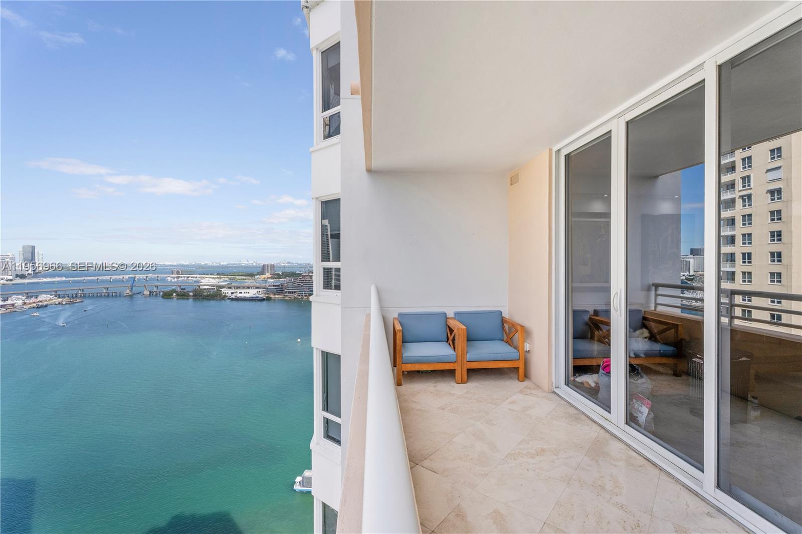 808 Brickell Key Drive, Unit 3007 Miami, FL 33131 - Photo 3 of 16 a view of a balcony with chair and table
