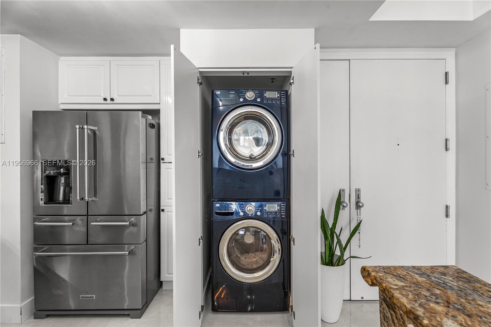 808 Brickell Key Drive, Unit 3007 Miami, FL 33131 - Photo 8 of 16 a kitchen with stainless steel appliances granite countertop a refrigerator and a stove