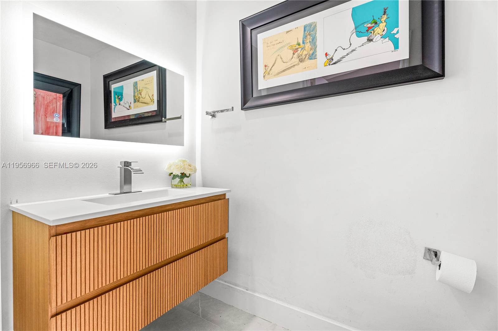 808 Brickell Key Drive, Unit 3007 Miami, FL 33131 - Photo 9 of 16 a bathroom with a sink and a mirror