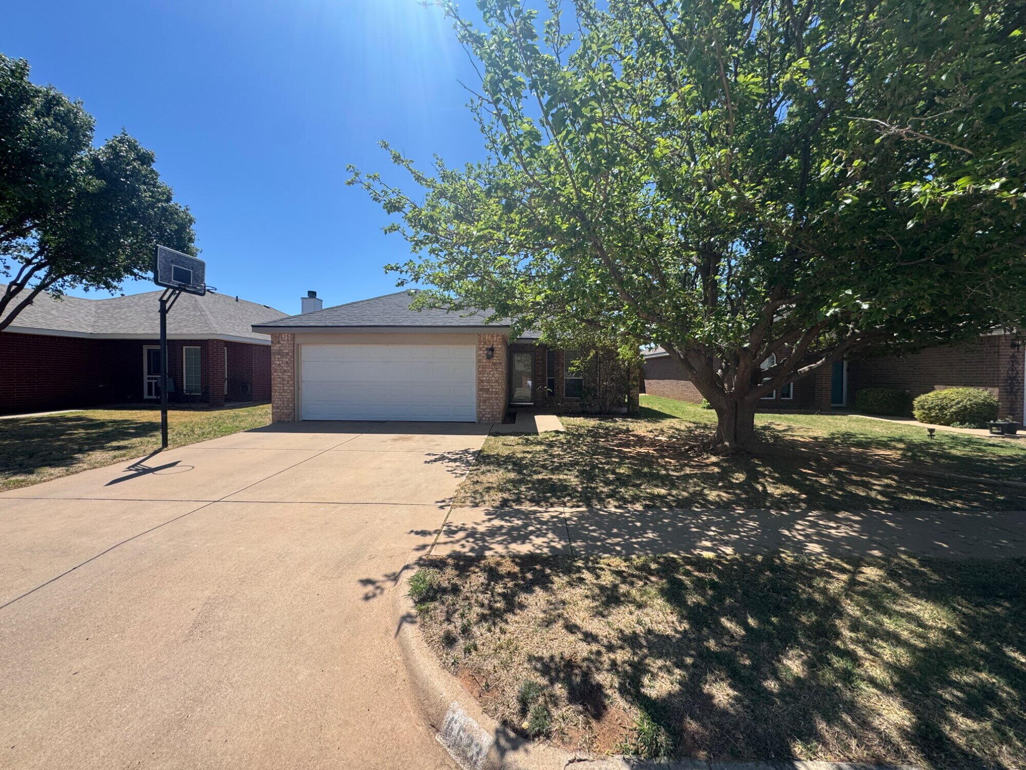 6523 88th Street Lubbock, TX 79424 - Photo 1 of 1 a front view of a house with a yard and garage