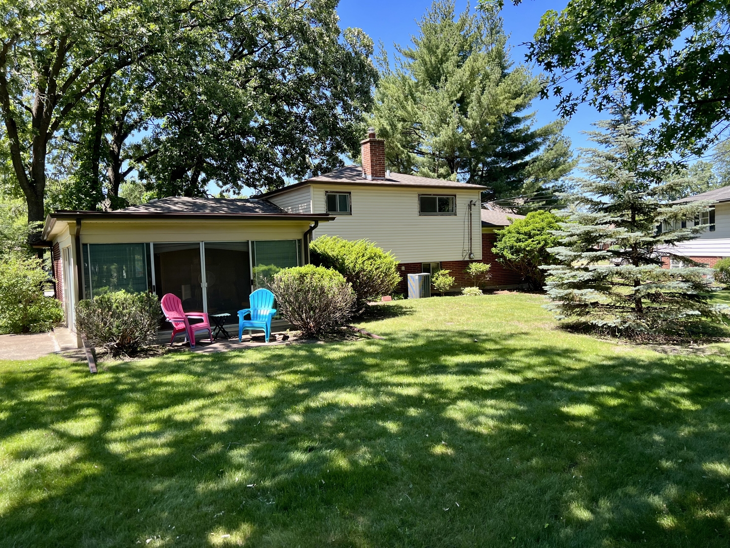 3819 Rugen Road Glenview, IL 60025 - Photo 22 of 24 a front view of a house with swing and a tree