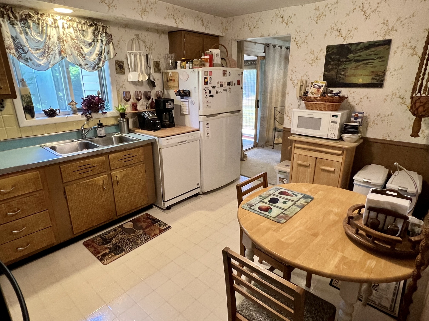 3819 Rugen Road Glenview, IL 60025 - Photo 9 of 24 a kitchen with stainless steel appliances kitchen island granite countertop a sink dishwasher stove and refrigerator with wooden floor