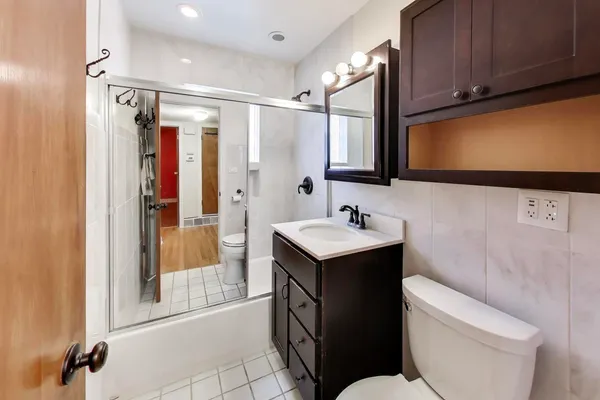 a bathroom with a sink toilet and shower