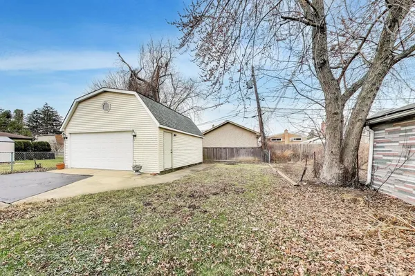 a big house with a large tree and yard