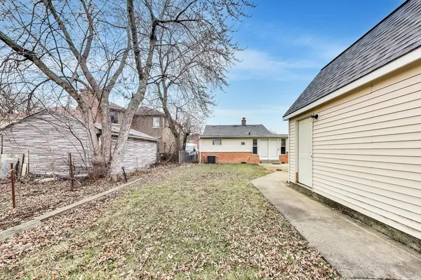 a white house that has a tree in front of it