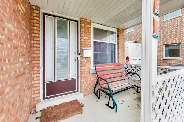 a view of a two chairs in the back yard of the house