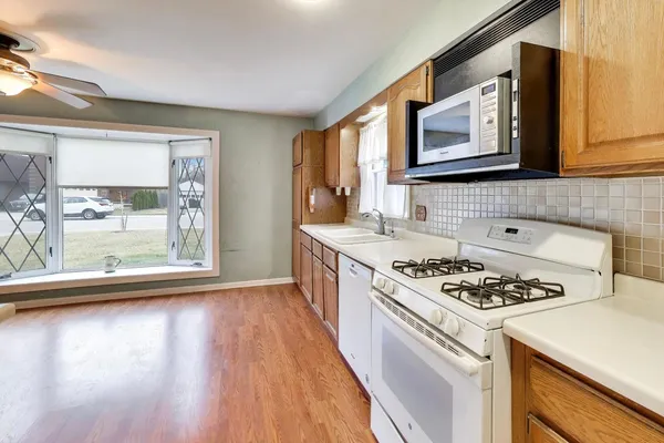 a kitchen with stainless steel appliances a stove a sink and a microwave