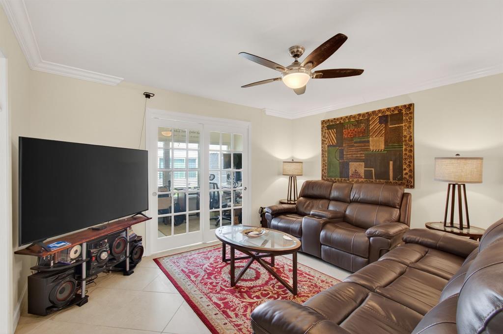19000 Stewart Circle, Unit 4 Boca Raton, FL 33496 - Photo 21 of 63 a living room with furniture a ceiling fan and a flat screen tv