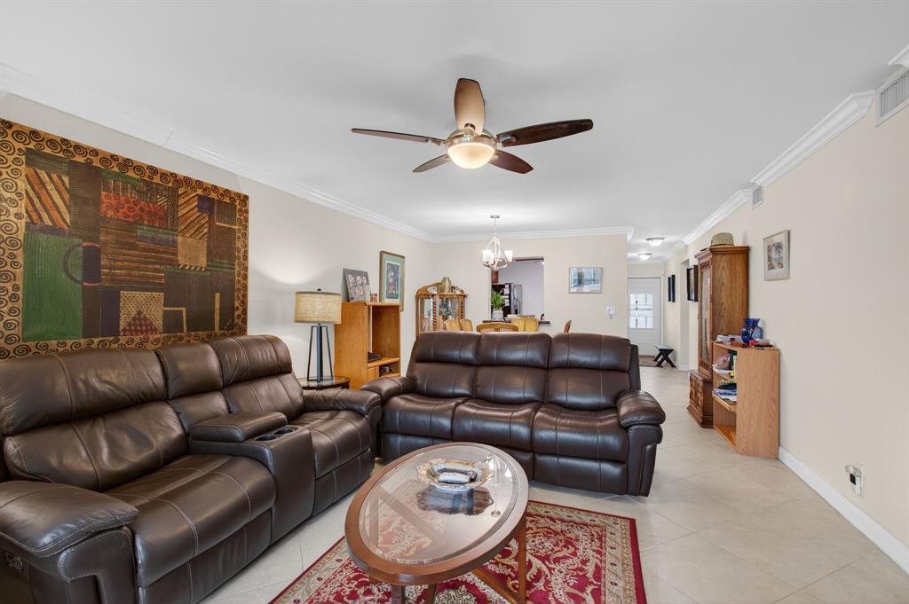 19000 Stewart Circle, Unit 4 Boca Raton, FL 33496 - Photo 23 of 63 a living room with furniture a ceiling fan and a rug