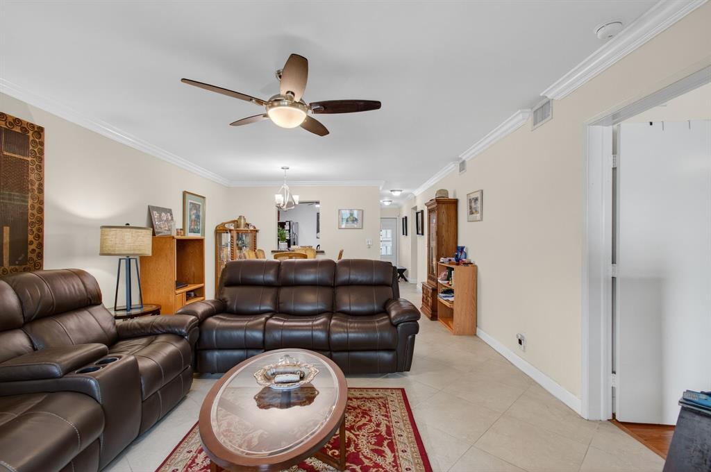 19000 Stewart Circle, Unit 4 Boca Raton, FL 33496 - Photo 24 of 63 a living room with furniture a ceiling fan and a rug