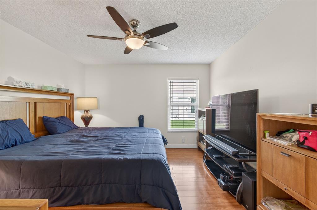 19000 Stewart Circle, Unit 4 Boca Raton, FL 33496 - Photo 30 of 63 a bedroom with a bed and a flat screen tv