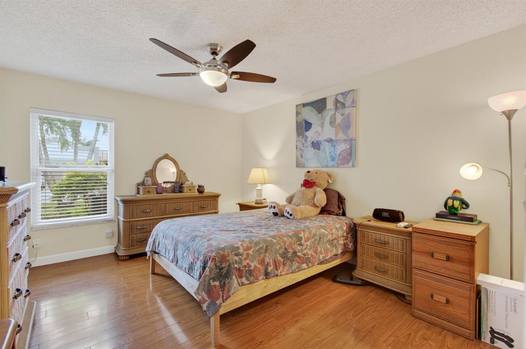 19000 Stewart Circle, Unit 4 Boca Raton, FL 33496 - Photo 38 of 63 a bedroom with a bed and a chandelier