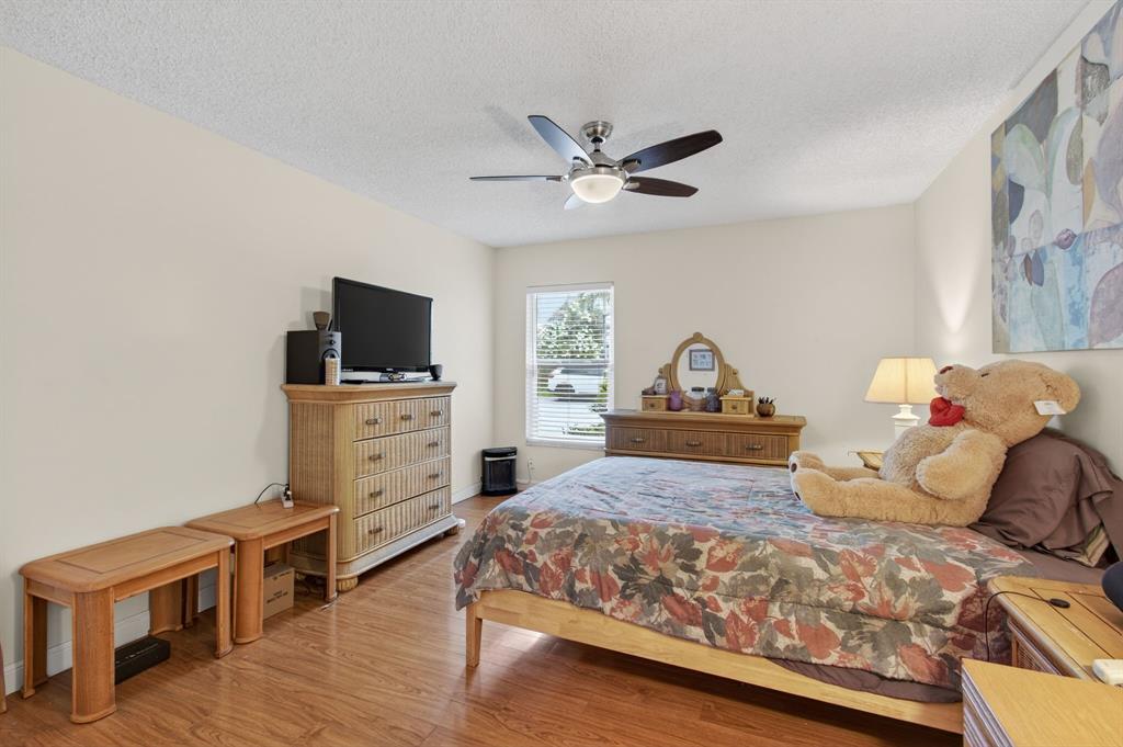 19000 Stewart Circle, Unit 4 Boca Raton, FL 33496 - Photo 39 of 63 a bedroom with a bed and a flat screen tv