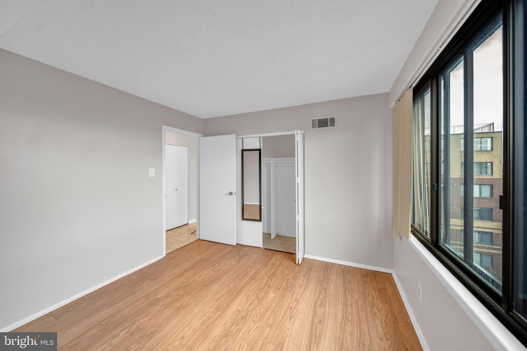 1245 13th Street Northwest, Unit 915 Washington, DC 20005 - Photo 19 of 22 a view of hallway with a large window and wooden floor