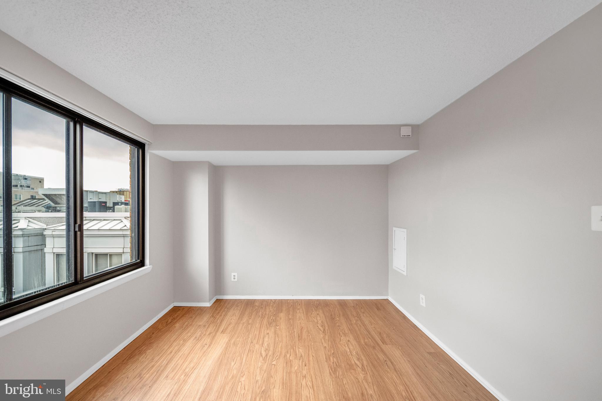 1245 13th Street Northwest, Unit 915 Washington, DC 20005 - Photo 20 of 22 wooden floor in an empty room with a window