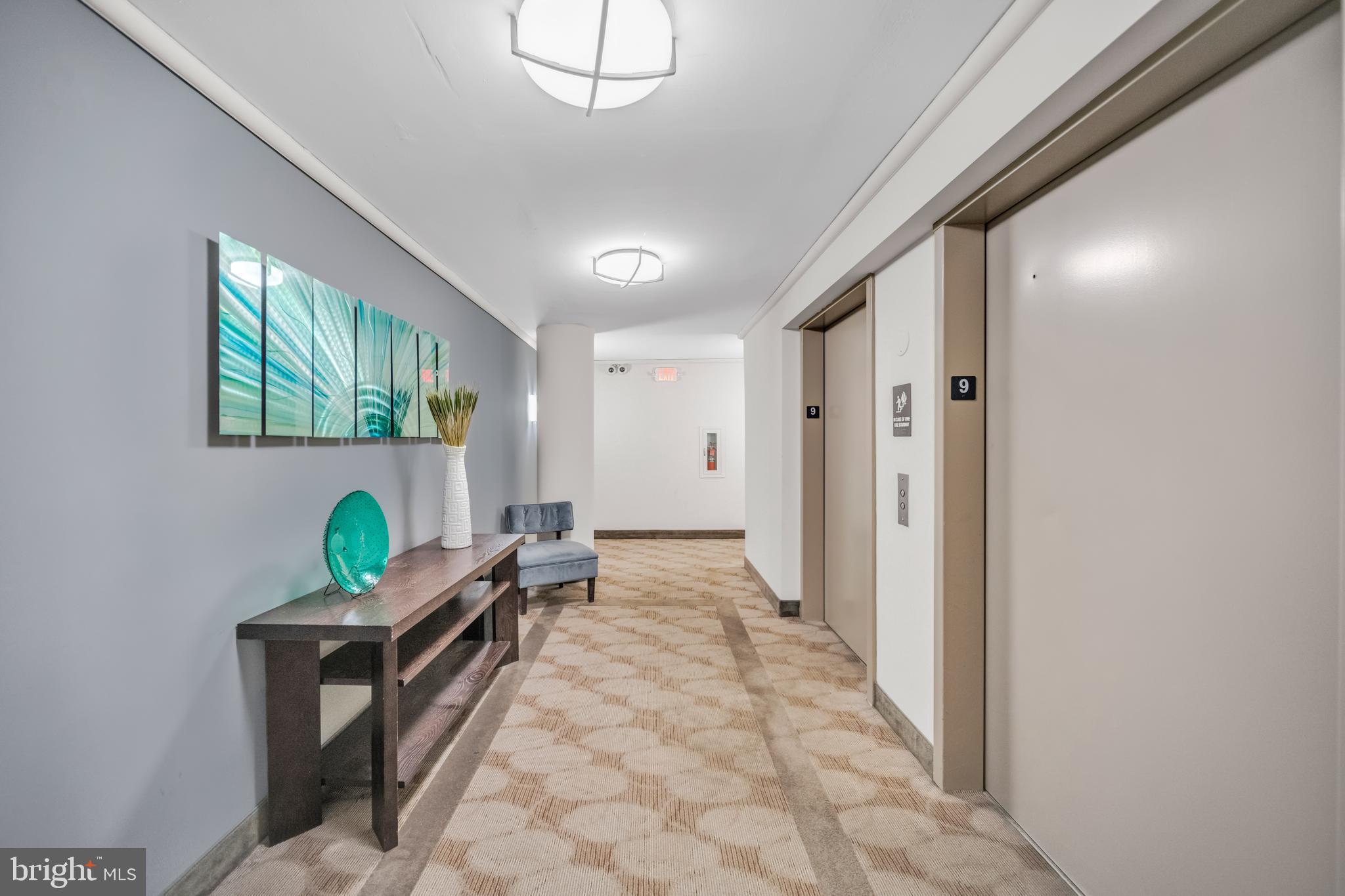 1245 13th Street Northwest, Unit 915 Washington, DC 20005 - Photo 4 of 22 a hallway with a bed and windows