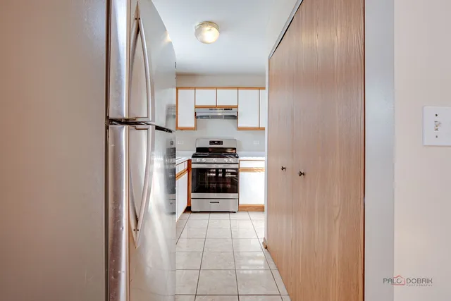 a kitchen with stainless steel appliances a refrigerator and a stove