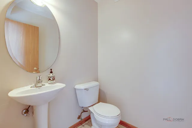 a bathroom with a sink mirror and toilet